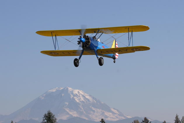 A Stearman flyby with Mt Rainier in the distance.