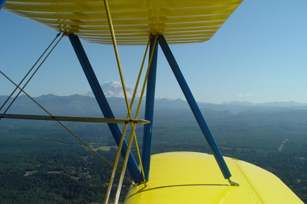 A view of Mt. Rainier through the wings of the Stearman.
