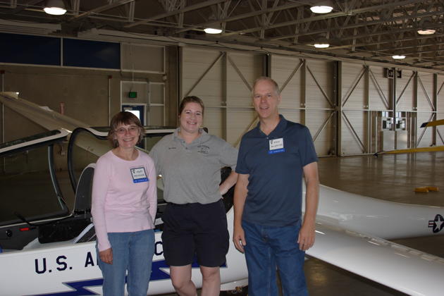 Mary and me with Maj Maggie Grafe and a new DG-1001 inside the USAF Academy hangar in Colorado. Photo by Jim Vincze.