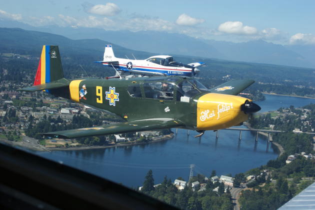 Bob Hill's IAR-823 and Ray Roussy's Navion fly formation departing Bremerton.