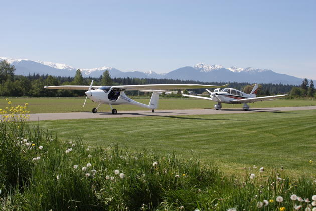 Paul Kuntz' Sinus N54PK and my Warrior N313DC on Paul's taxiway at Sequim Valley airport on 10 May 2013.