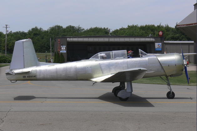 Nanchang CJ-6A N280NC in bare aluminum finish in Pennsylvania with its previous owner, Ed Lovejoy. Photo by Terry Shepherd.