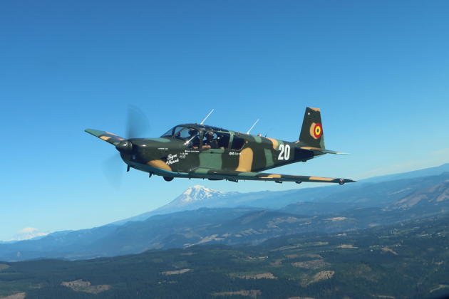Vic Norris in his IAR823, with Tom Burlace in the right seat, in formation with the Navion. Mt Adams and Mt Rainier are in the distance. Photo by Mary Kasprzyk.