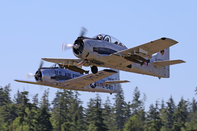 Roger Collins in his T-28 'Lumpy' leading Charlie Goldbach and his T-28 on a formation takeoff at Bremerton. Photo by Dan Shoemaker.