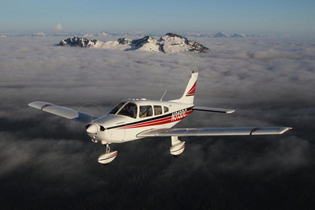 3DC cruising above the broken clouds just east of Mt Pilchuck in the Cascades. Photo by and courtesy of Jason Fortenbacher.