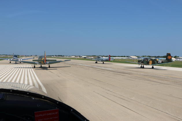 On Oshkosh runway 27 for a 7-ship departure.