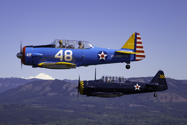 Roger Collins and Bob Jones joining in their T-6s after departing Arlington. Photo by Dan Shoemaker.