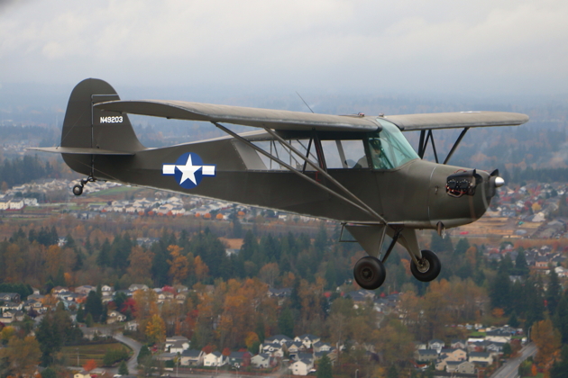 Dan Barry in his Aeronca L-3 in close formation as the weather slightly cleared.