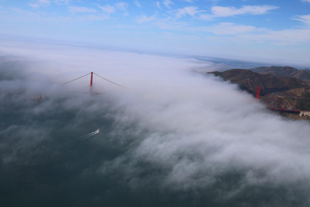 Cooling ocean clouds stream through the Golden Gate bridge, with a heat dome overhead. My photo.