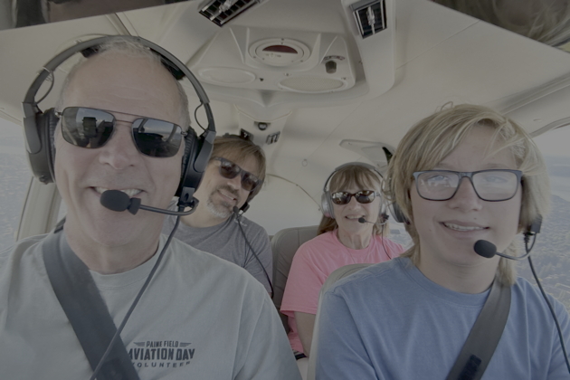 Alex as pilot-in-command with David and Baba in back. My photo.