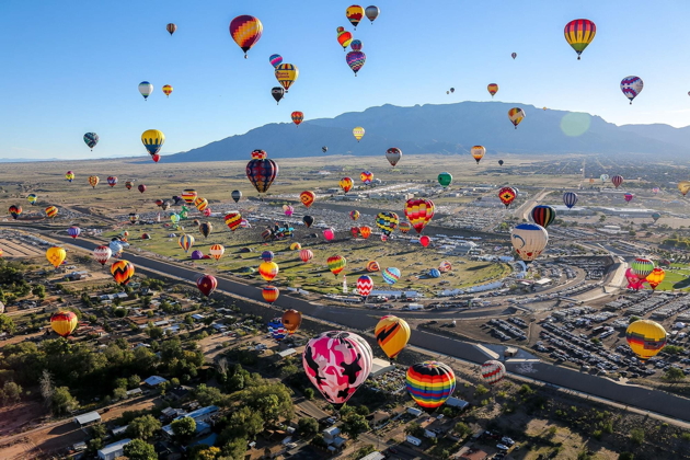 A great view of Balloon Fiesta Park, airborne balloons and the Sandia Mountains at the Albuquerque Balloon Fiesta. Bennie Bos photo.