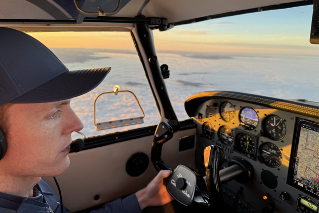 Kevin preparing to start our descent into a sea of clouds over the Puget Sound in the Comanche. My photo.